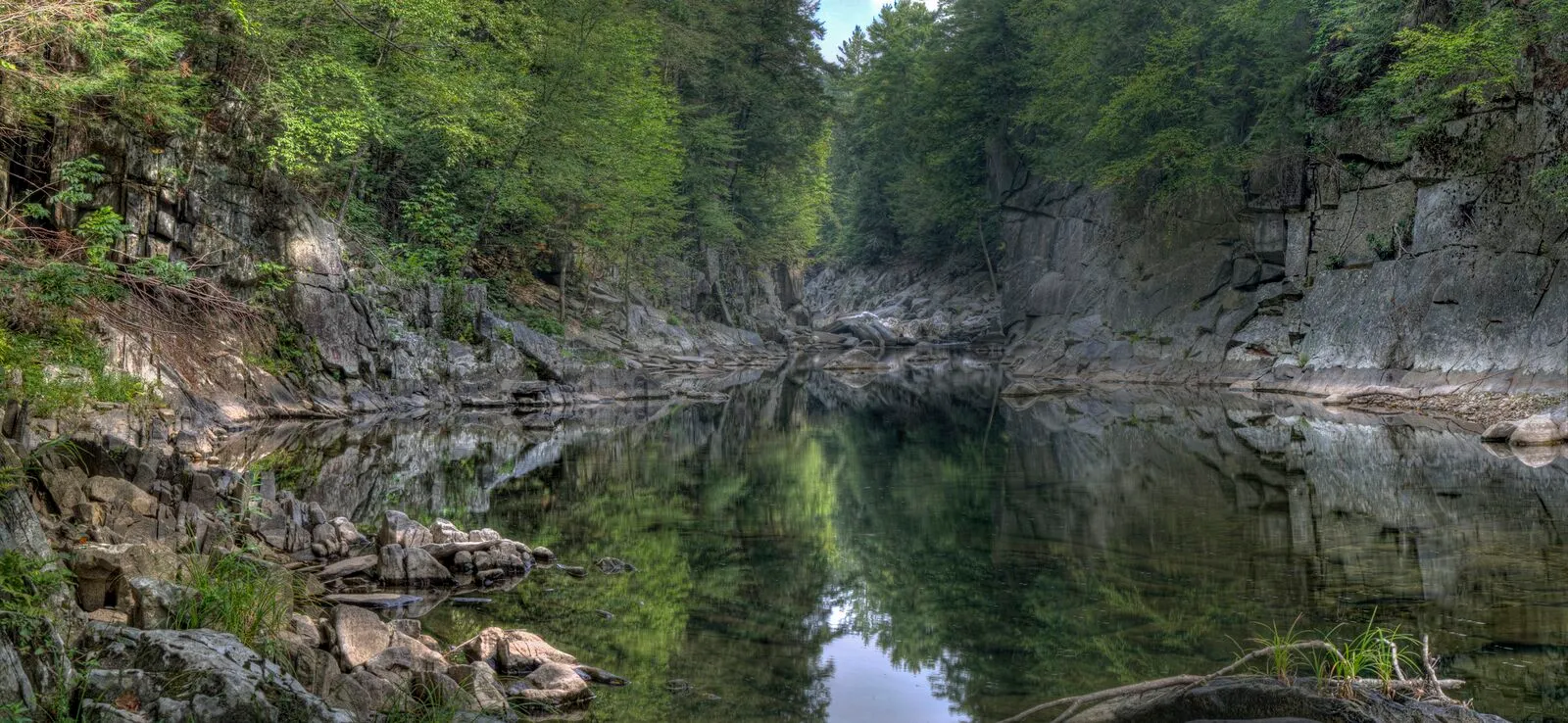 Panoramic view of Chesterfield Gorge with the East Branch of the Westfield River cutting through granite cliffs, framed by hemlock and pine.